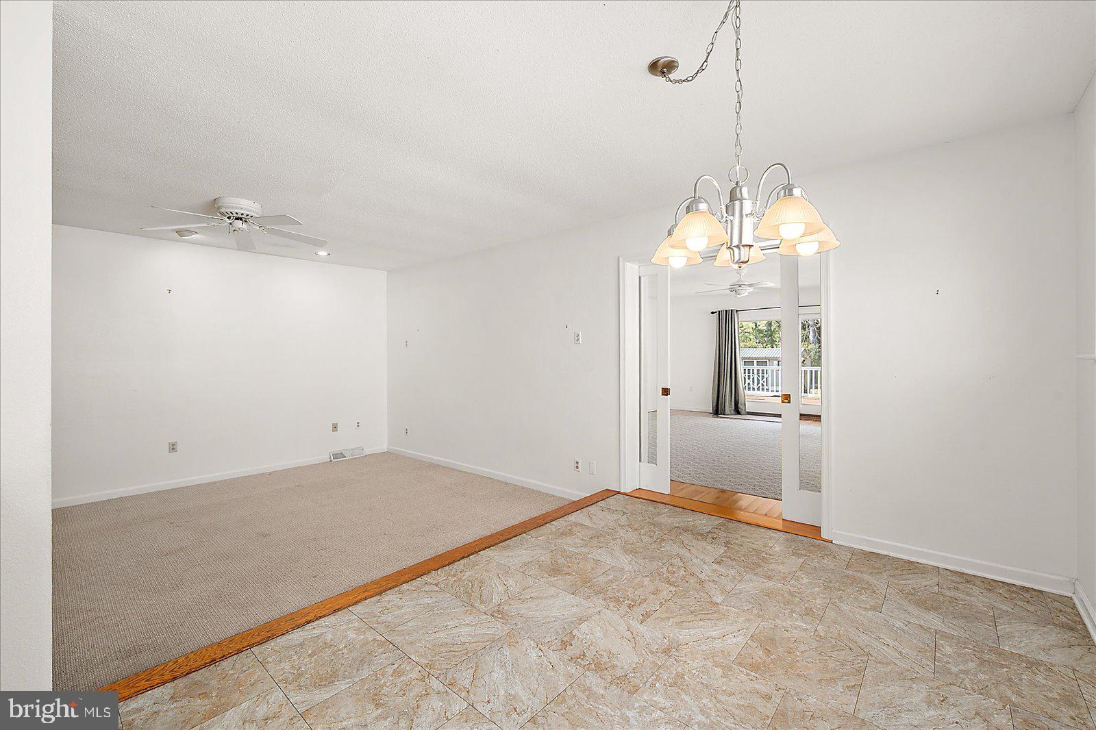 10505 Keyser Point Road Ocean City, MD 21842 - Photo 21 of 53 a view of a livingroom with a chandelier fan and windows