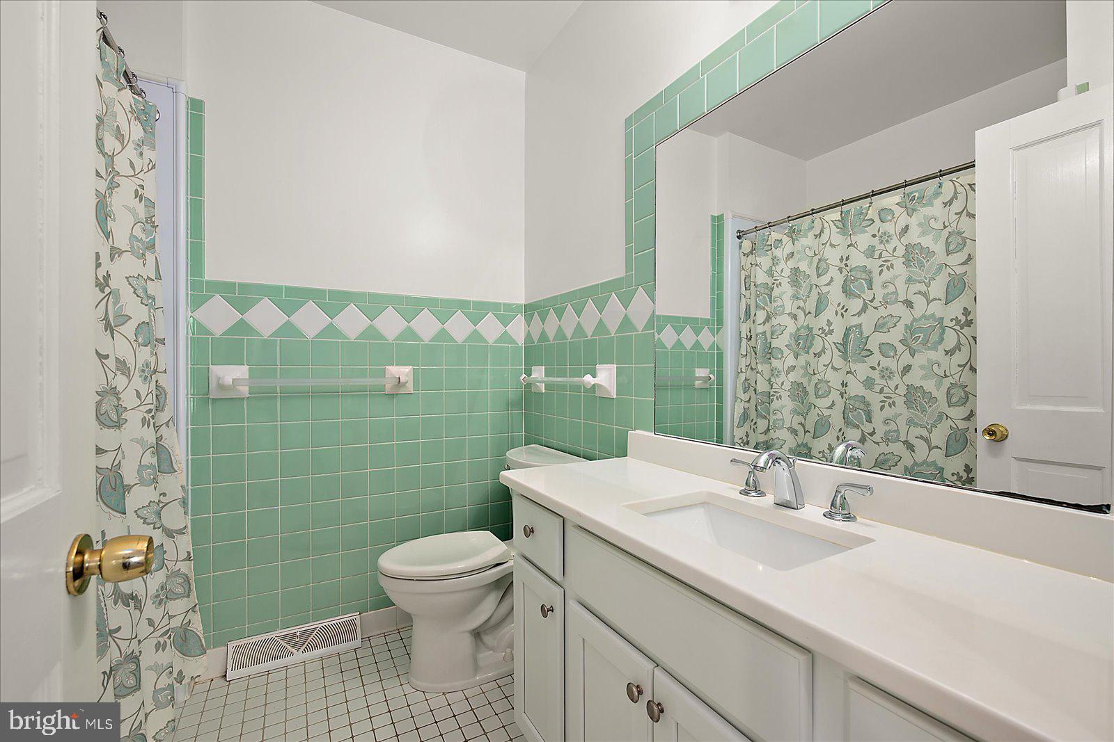 10505 Keyser Point Road Ocean City, MD 21842 - Photo 38 of 53 a bathroom with a sink a toilet and shower curtain