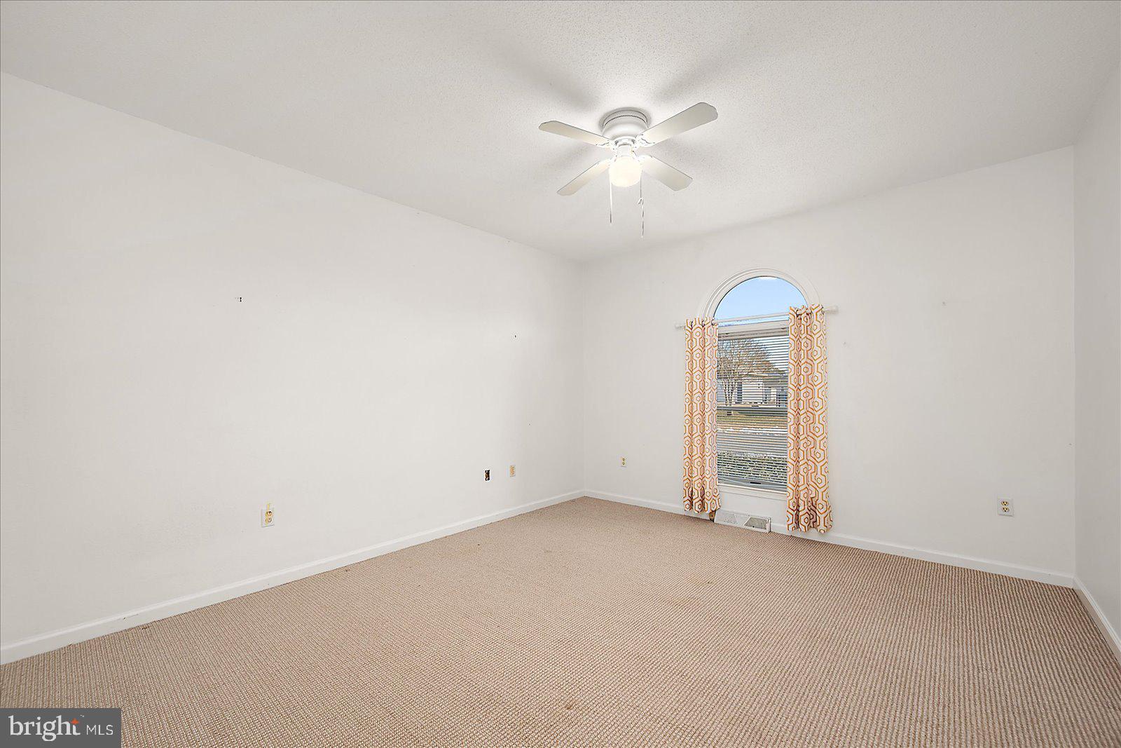 10505 Keyser Point Road Ocean City, MD 21842 - Photo 39 of 53 an empty room with windows and fan