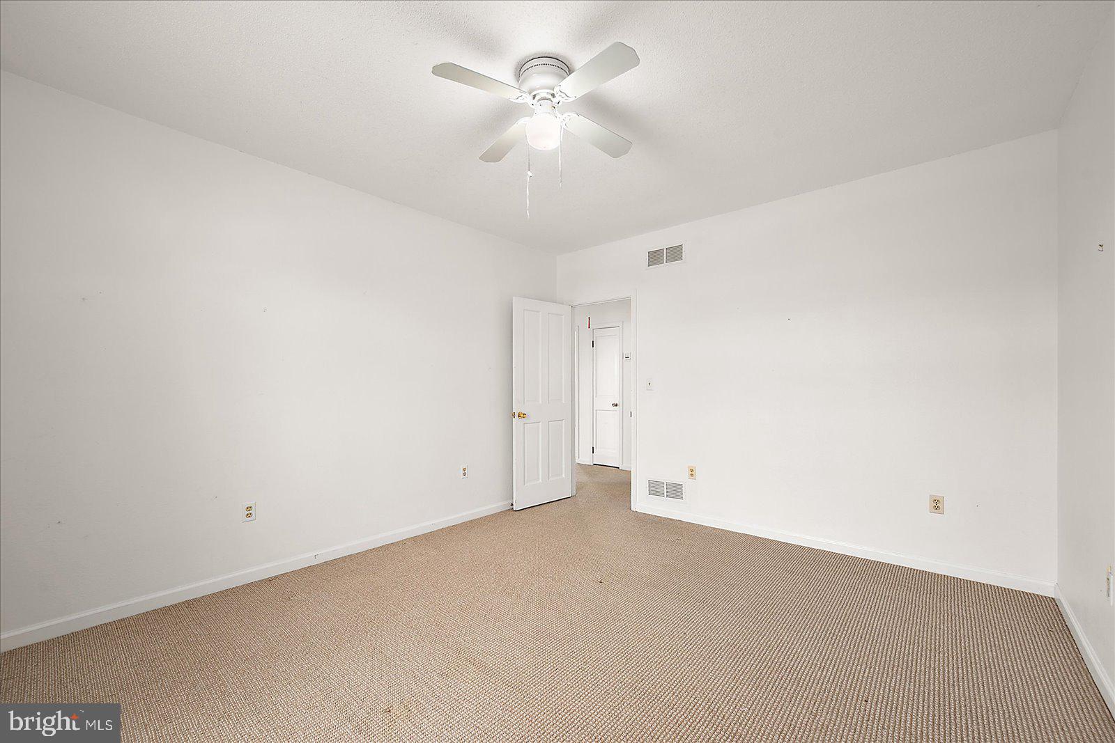 10505 Keyser Point Road Ocean City, MD 21842 - Photo 40 of 53 an empty room with a ceiling fan and a ceiling fan