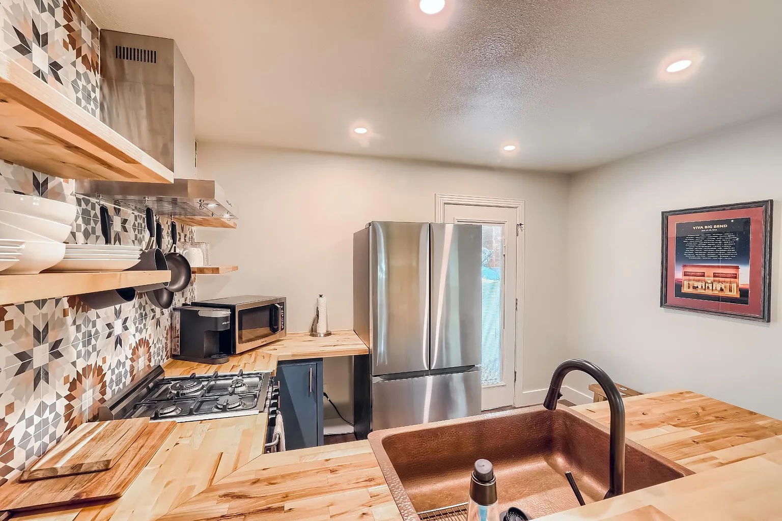 5600 Ledesma Road Austin, TX 78721 - Photo 32 of 36 Butcher block countertops and custom tile accents bring warmth and character to this modern kitchen.