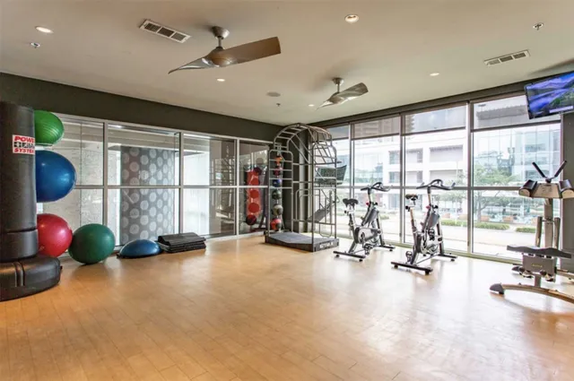 a view of a room with gym equipment and floor to ceiling window