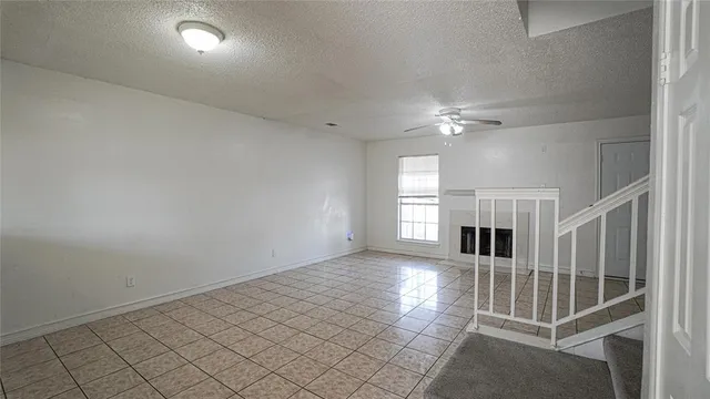 an empty room with white walls and windows