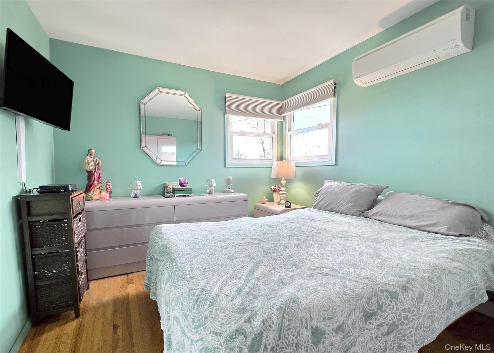 430 Heathcote Road Lindenhurst, NY 11757 - Photo 11 of 22 a living room with a couch and a flat screen tv