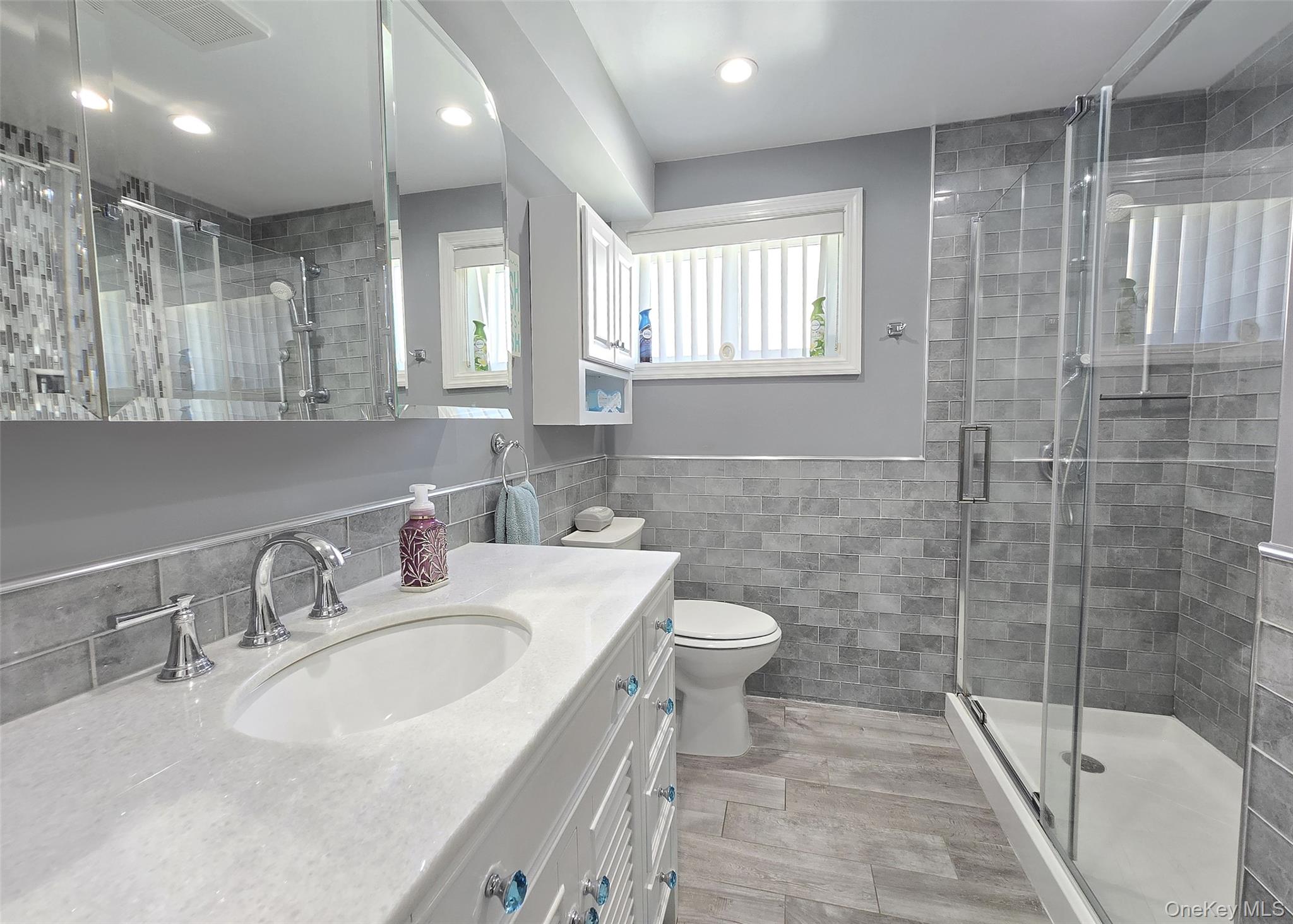 430 Heathcote Road Lindenhurst, NY 11757 - Photo 14 of 22 a bathroom with a sink toilet and shower