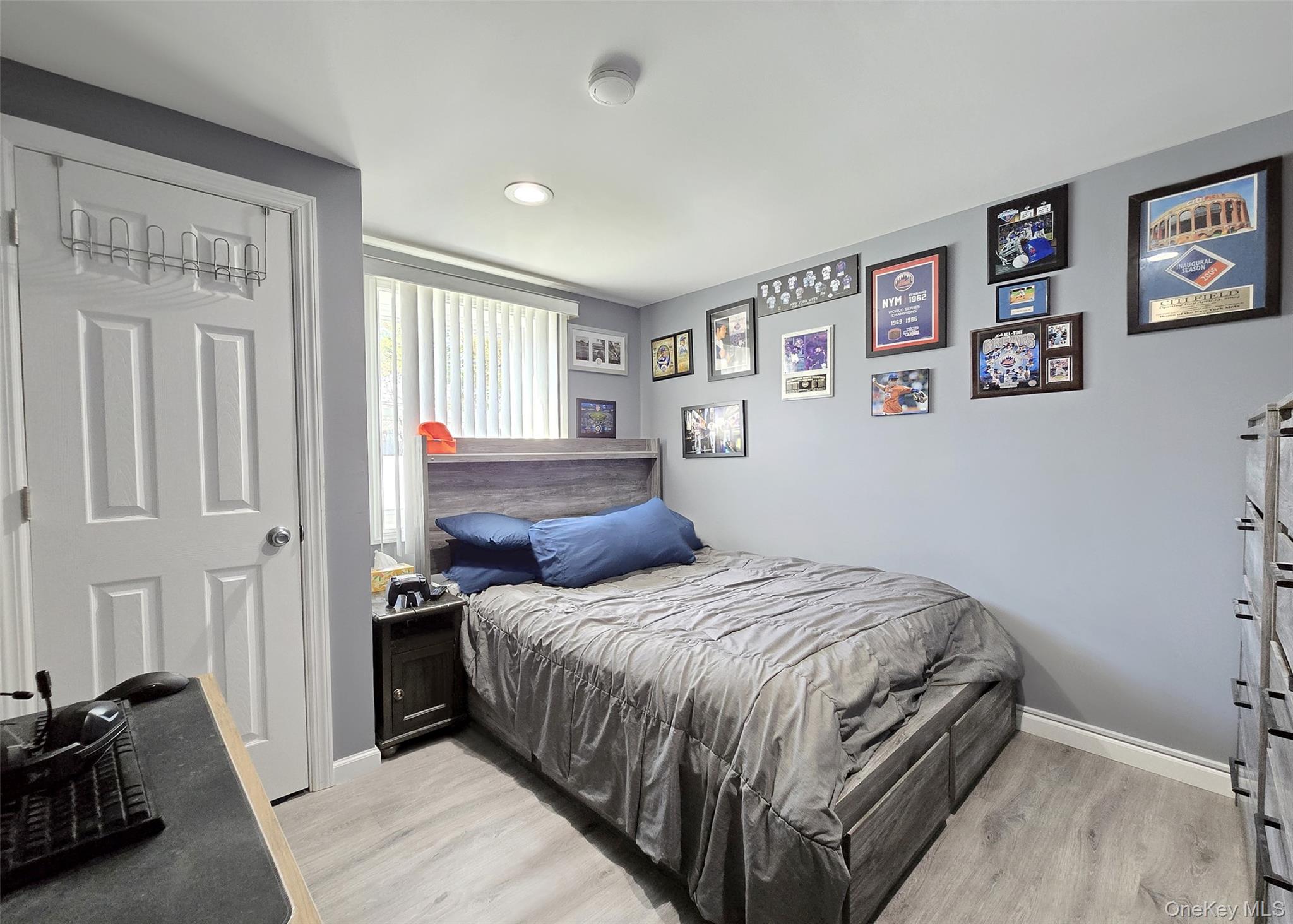 430 Heathcote Road Lindenhurst, NY 11757 - Photo 15 of 22 a bedroom with a bed and a couch