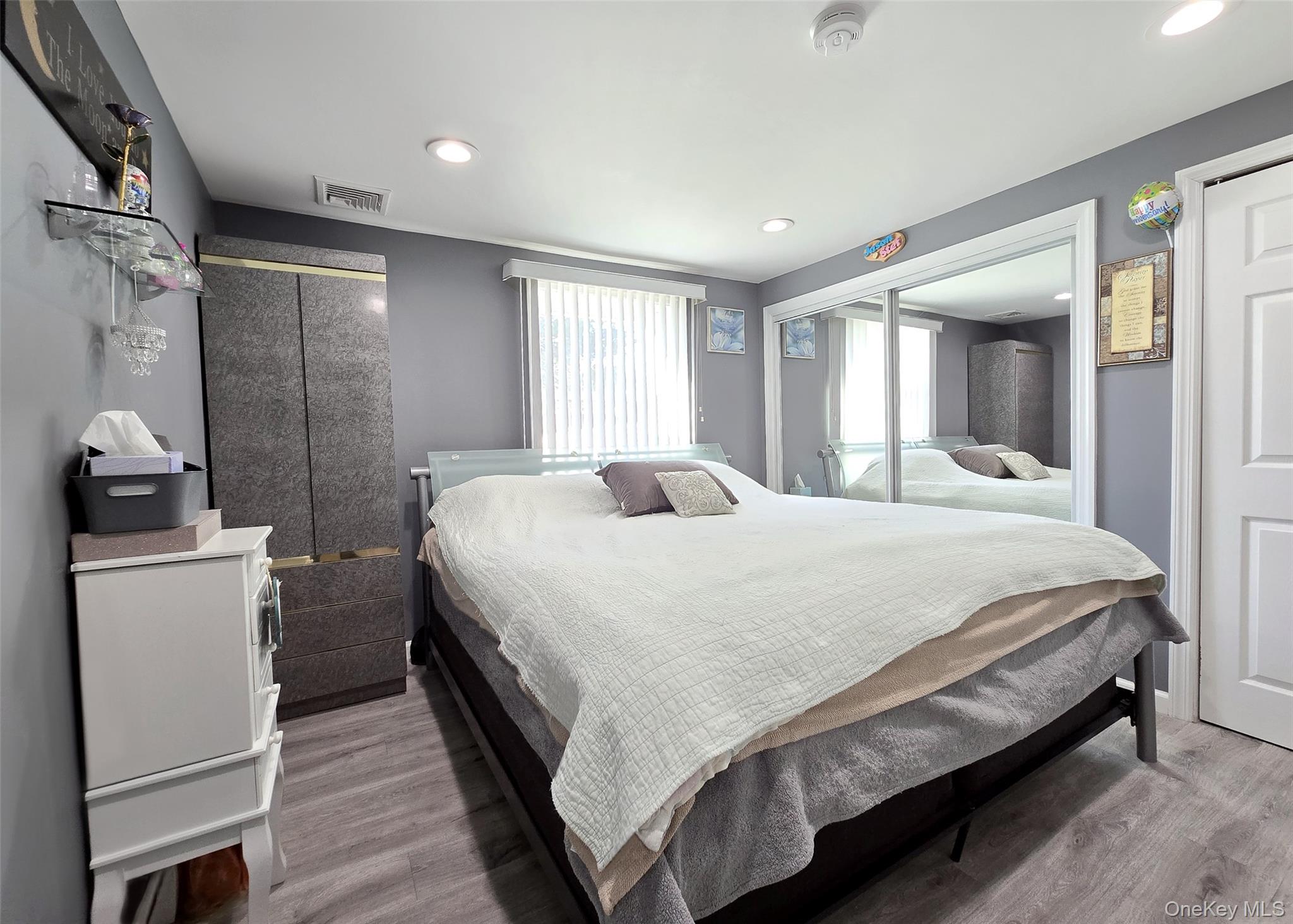 430 Heathcote Road Lindenhurst, NY 11757 - Photo 17 of 22 a bedroom with a bed and a refrigerator