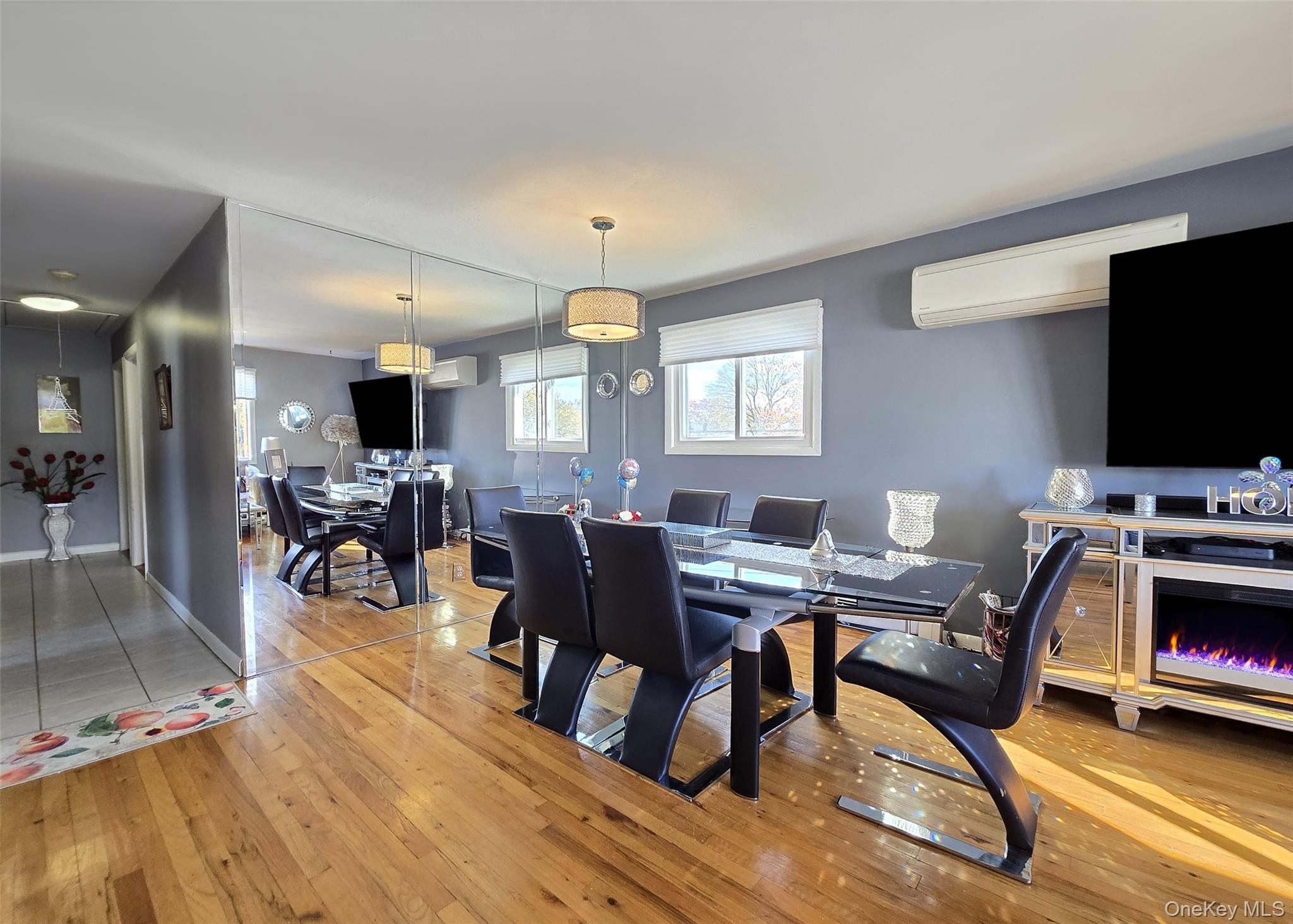 430 Heathcote Road Lindenhurst, NY 11757 - Photo 4 of 22 a view of a dining room with furniture and a flat screen tv