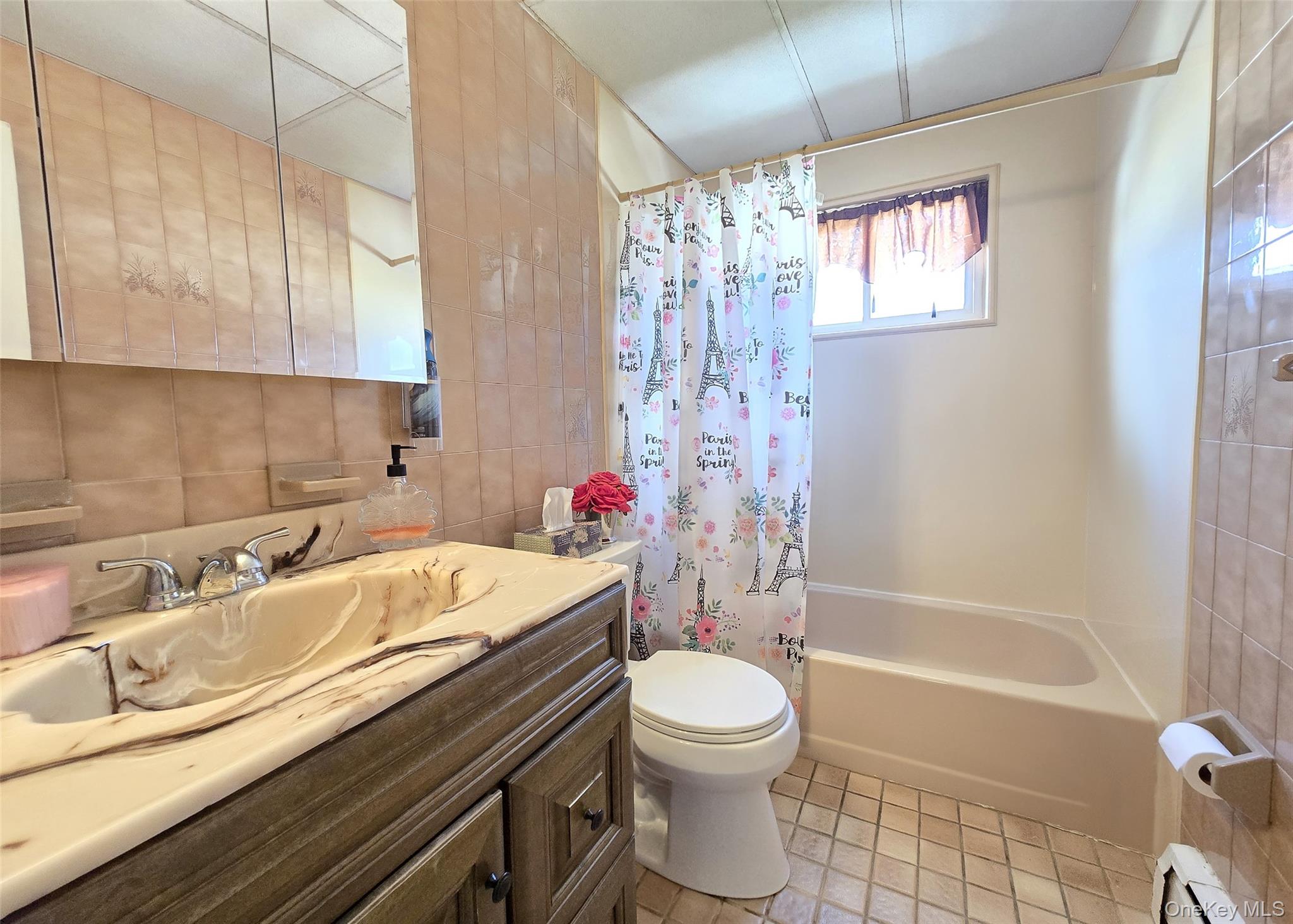430 Heathcote Road Lindenhurst, NY 11757 - Photo 7 of 22 a bathroom with a sink a toilet and shower