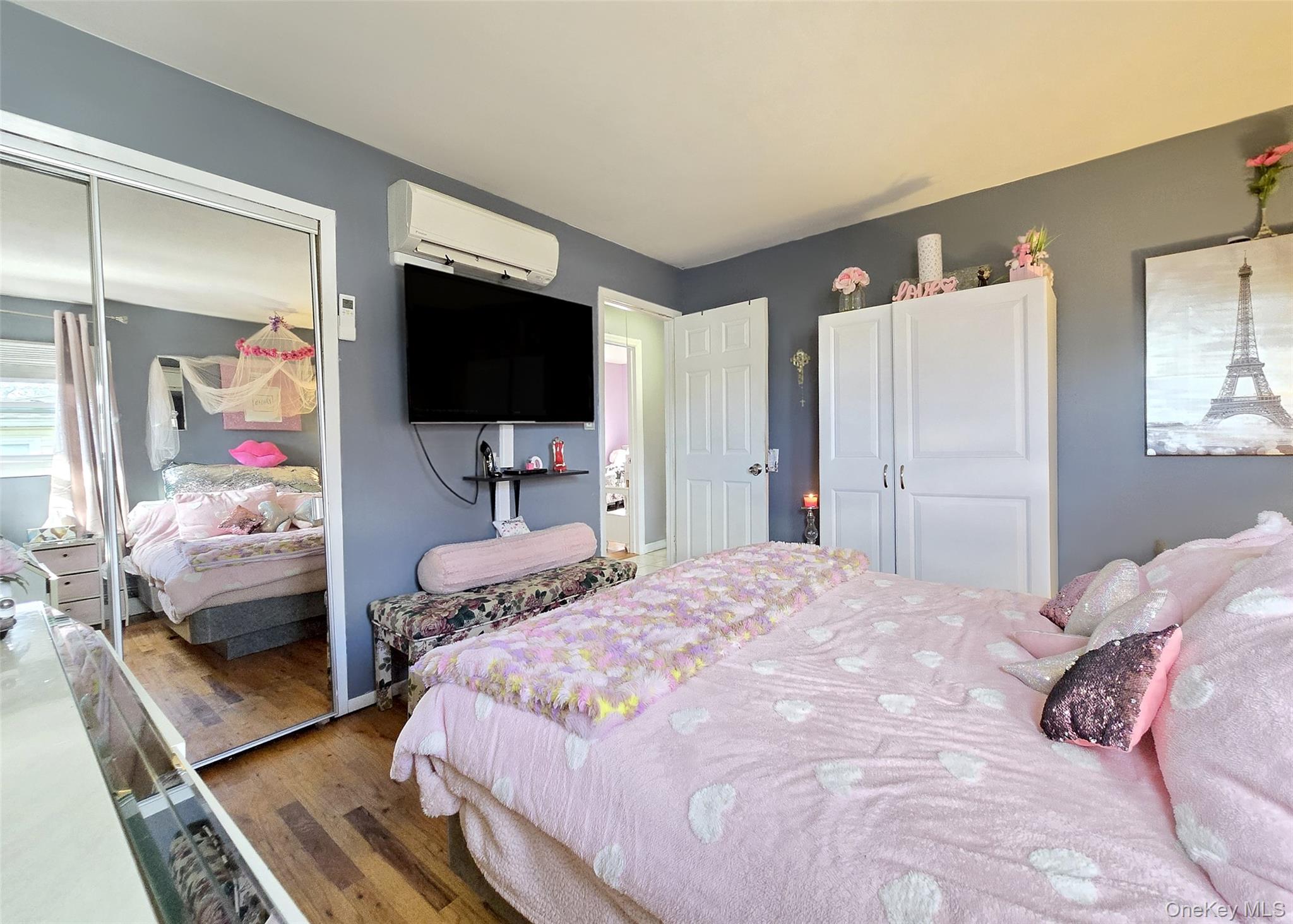 430 Heathcote Road Lindenhurst, NY 11757 - Photo 9 of 22 a bedroom with a bed and flat tv screen