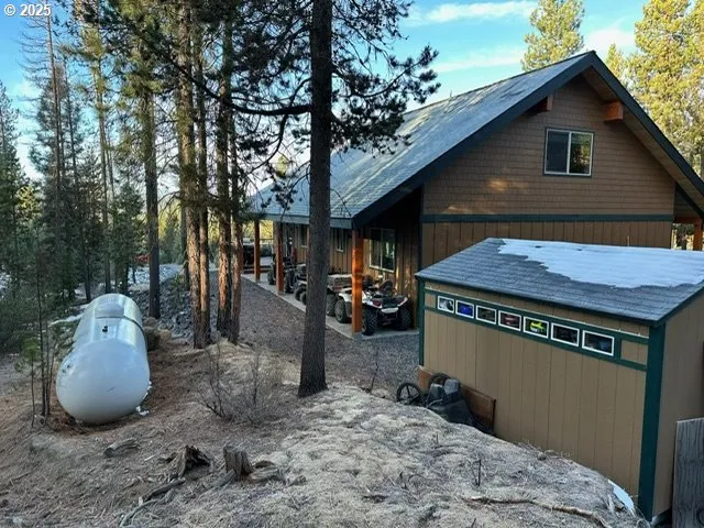 a view of a chairs and table in backyard