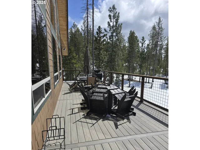 a view of a roof deck with table and chairs with wooden floor