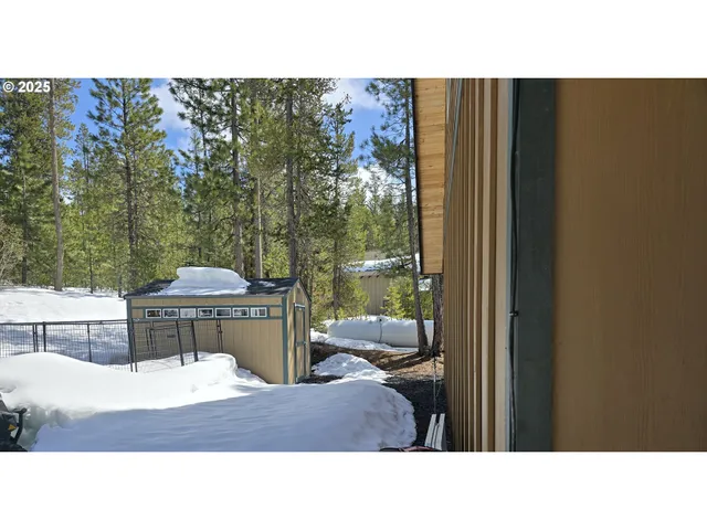 a open cabinet with yard and chair