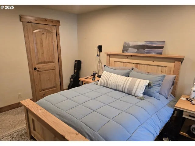a bedroom with a bed and a mirror