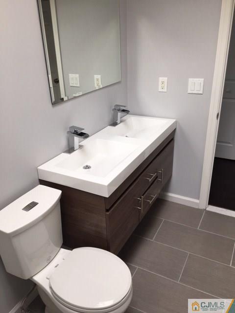65 Old Post Road Edison, NJ 08817 - Photo 16 of 25 a bathroom with a sink a toilet and mirror