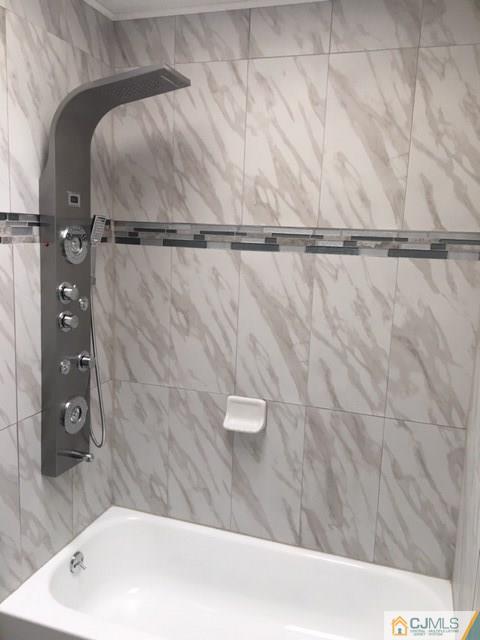 65 Old Post Road Edison, NJ 08817 - Photo 18 of 25 a bathroom with a bathtub and a shower