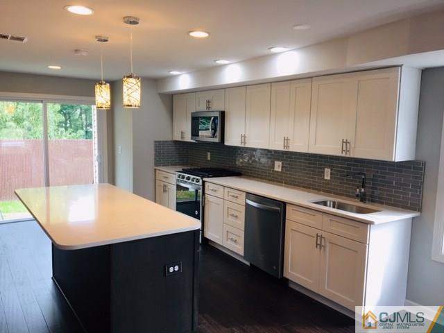 65 Old Post Road Edison, NJ 08817 - Photo 3 of 25 a kitchen with stainless steel appliances granite countertop a sink and a stove