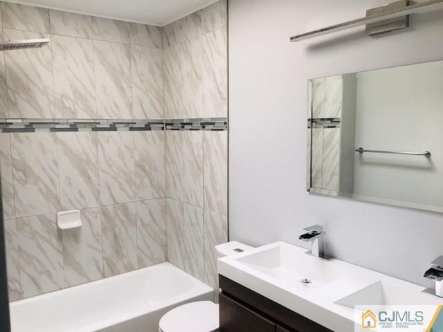 65 Old Post Road Edison, NJ 08817 - Photo 22 of 25 a bathroom with a sink and mirror with toilet