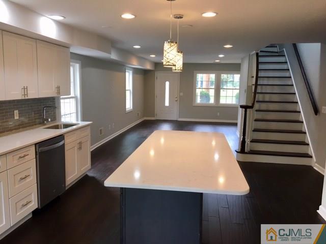 65 Old Post Road Edison, NJ 08817 - Photo 24 of 25 a kitchen with kitchen island a sink stainless steel appliances and cabinets