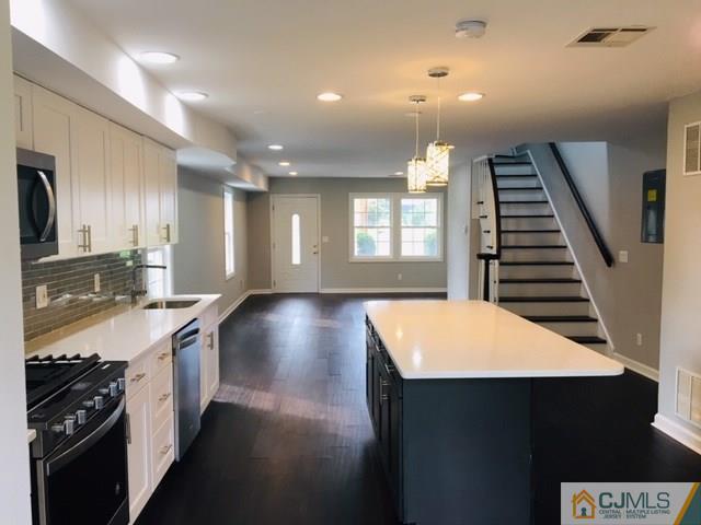 65 Old Post Road Edison, NJ 08817 - Photo 4 of 25 a kitchen with stainless steel appliances kitchen island a stove and a refrigerator