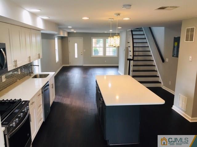 65 Old Post Road Edison, NJ 08817 - Photo 5 of 25 a kitchen with a sink and a stove top oven