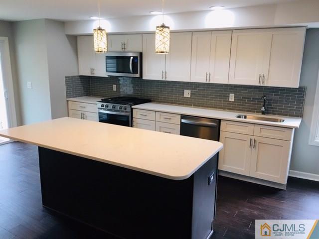 65 Old Post Road Edison, NJ 08817 - Photo 7 of 25 a kitchen with a sink stove and microwave