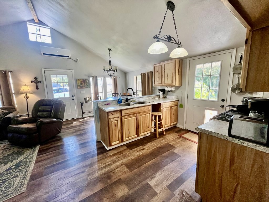 114 Elm Branch Street Huntington, TX 75949 - Photo 6 of 14 a kitchen with stainless steel appliances granite countertop a stove top oven a refrigerator a sink dishwasher a dining table and chairs with wooden floor