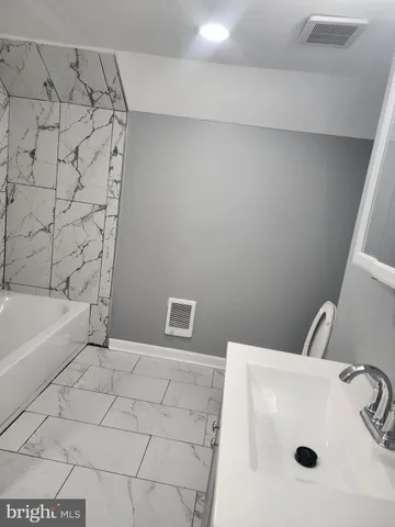 a bathroom with a sink and a bathtub