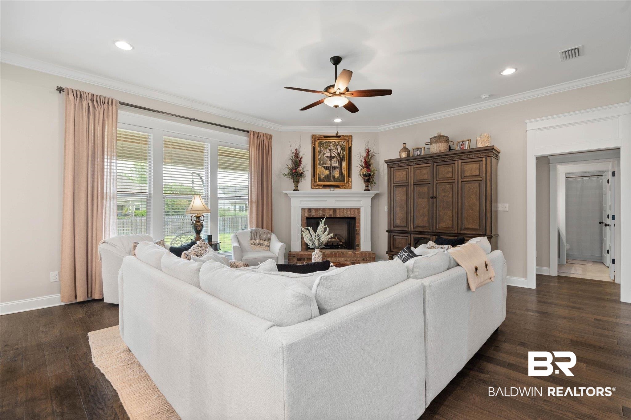 24821 Austin Road Daphne, AL 36526 - Photo 5 of 24 Living area with ceiling fan, dark wood finished floors, a fireplace, recessed lighting, and crown molding