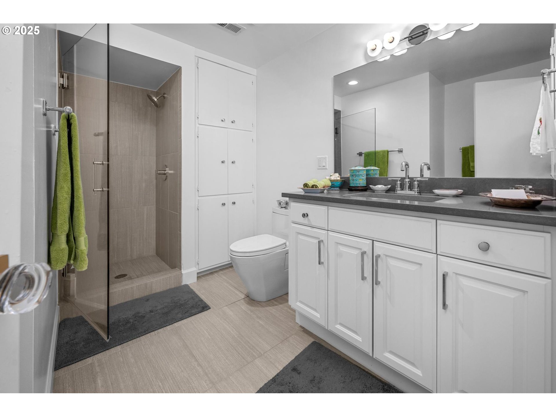 40 Southwest Condolea Court Lake Oswego, OR 97035 - Photo 27 of 39 a spacious bathroom with a granite countertop sink a toilet a mirror and shower