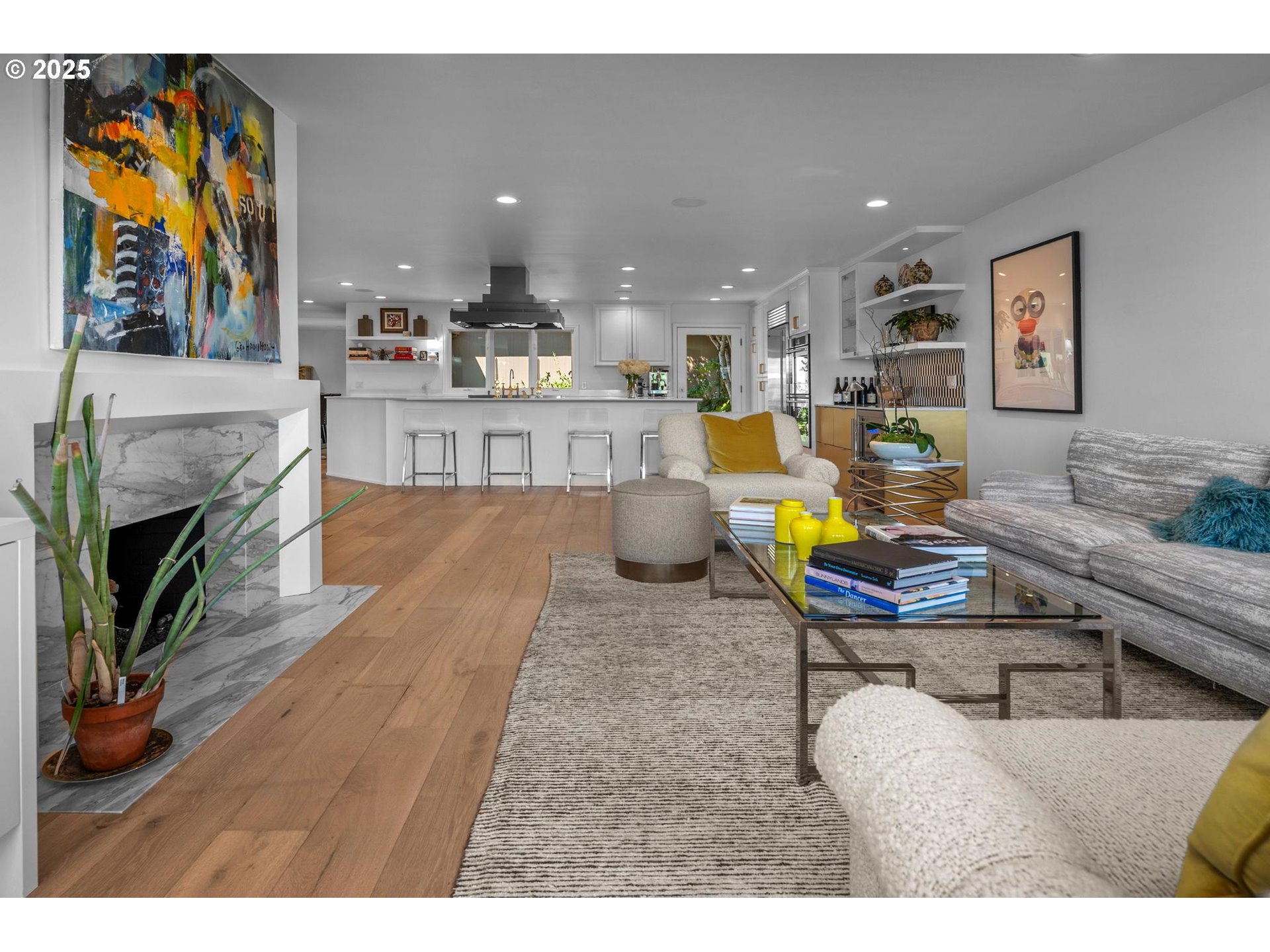 40 Southwest Condolea Court Lake Oswego, OR 97035 - Photo 4 of 39 a living room with furniture a fireplace and a kitchen view