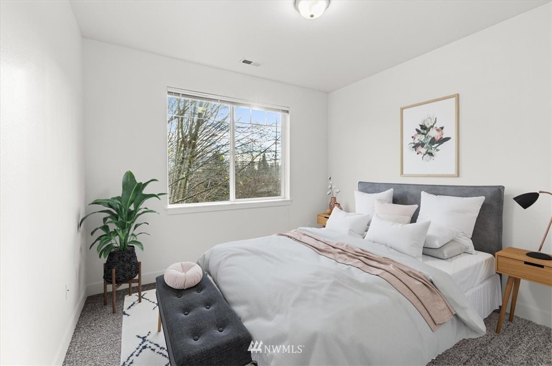 19102 20th Drive Southeast, Unit B206 Bothell, WA 98012 - Photo 21 of 29 a bedroom with bed and a window