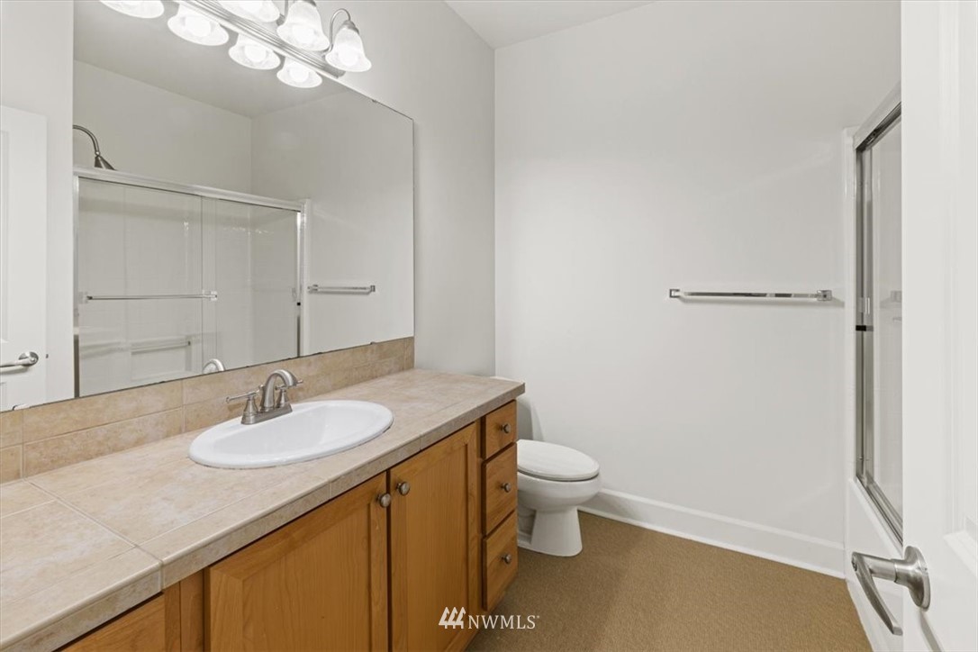 19102 20th Drive Southeast, Unit B206 Bothell, WA 98012 - Photo 23 of 29 a bathroom with a sink a toilet and shower