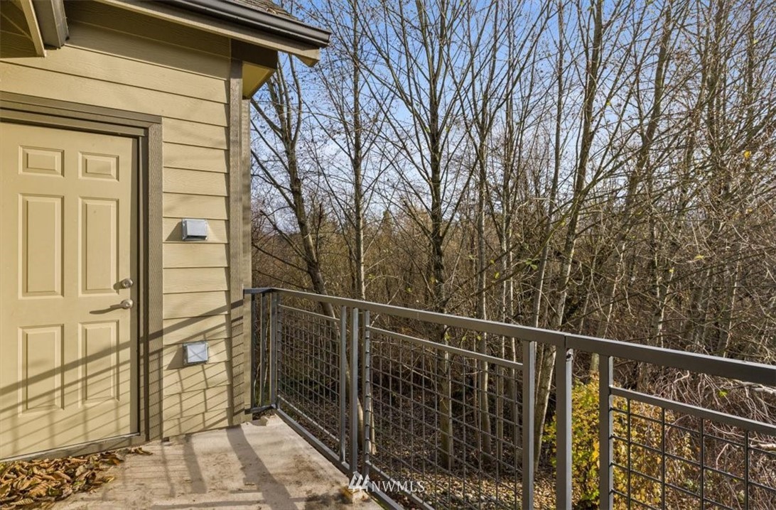 19102 20th Drive Southeast, Unit B206 Bothell, WA 98012 - Photo 26 of 29 a view of a balcony with wooden floor and fence