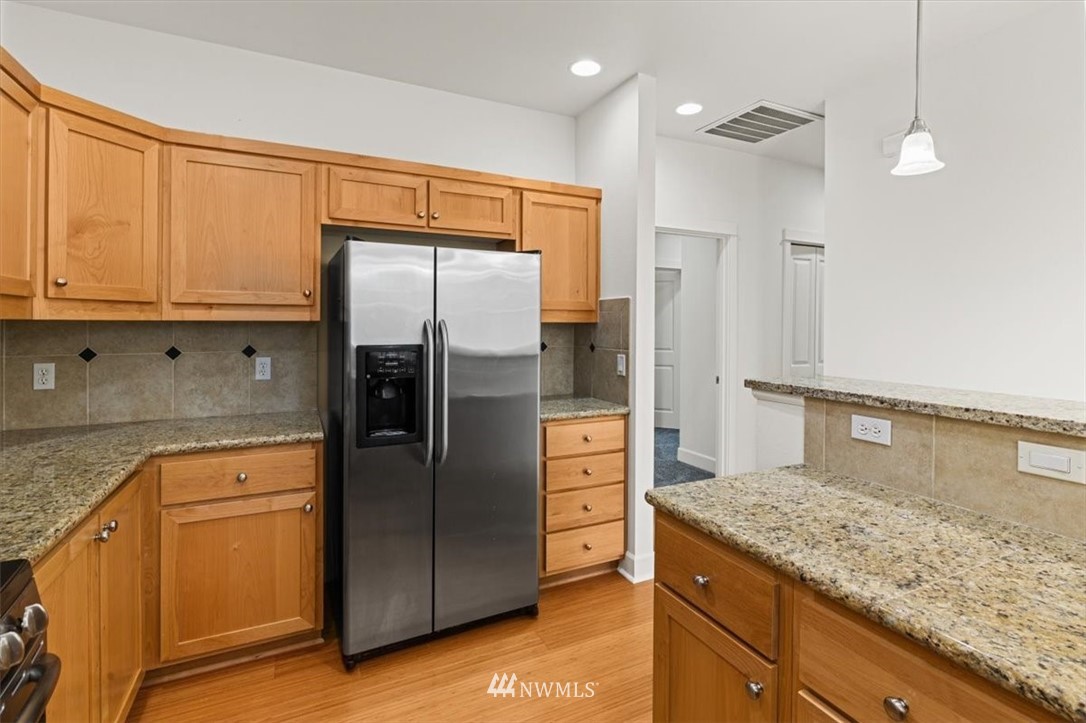 19102 20th Drive Southeast, Unit B206 Bothell, WA 98012 - Photo 10 of 29 a kitchen with stainless steel appliances granite countertop a refrigerator and a sink