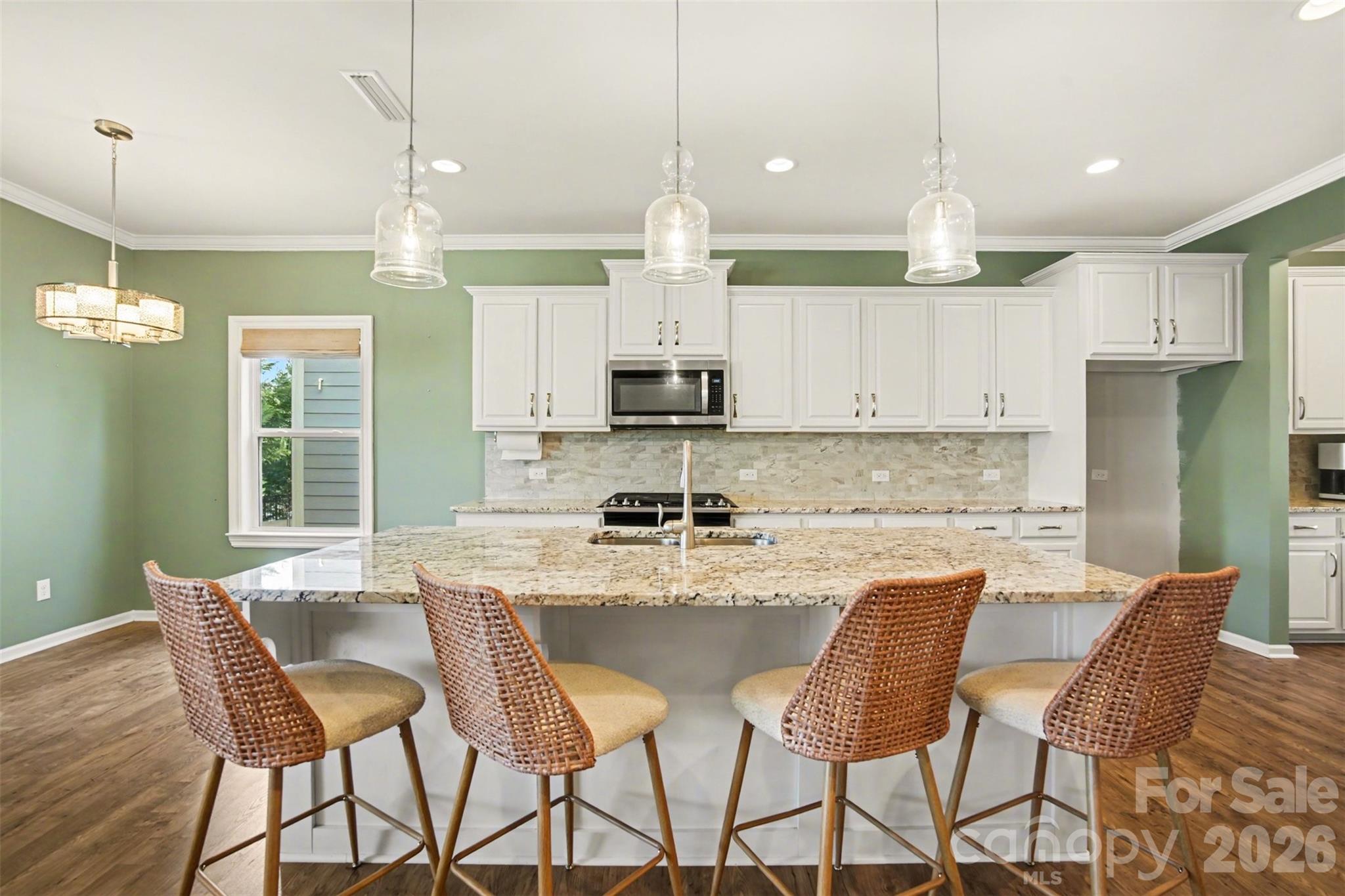 2013 Fuschia Court Tega Cay, SC 29708 - Photo 5 of 47 a kitchen with stainless steel appliances granite countertop a dining table chairs and a refrigerator