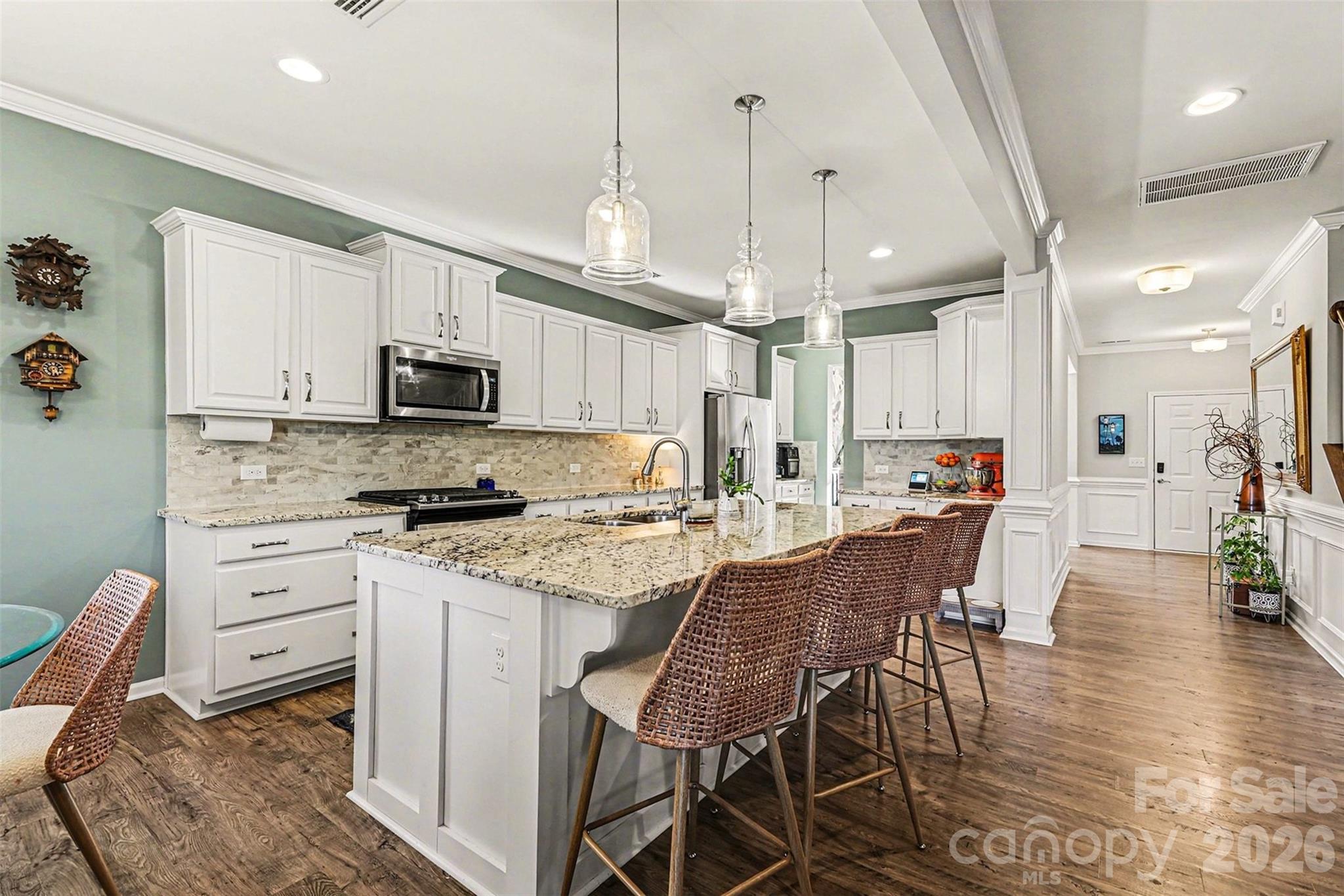 2013 Fuschia Court Tega Cay, SC 29708 - Photo 6 of 47 a kitchen with stainless steel appliances kitchen island granite countertop a wooden floor and white cabinets