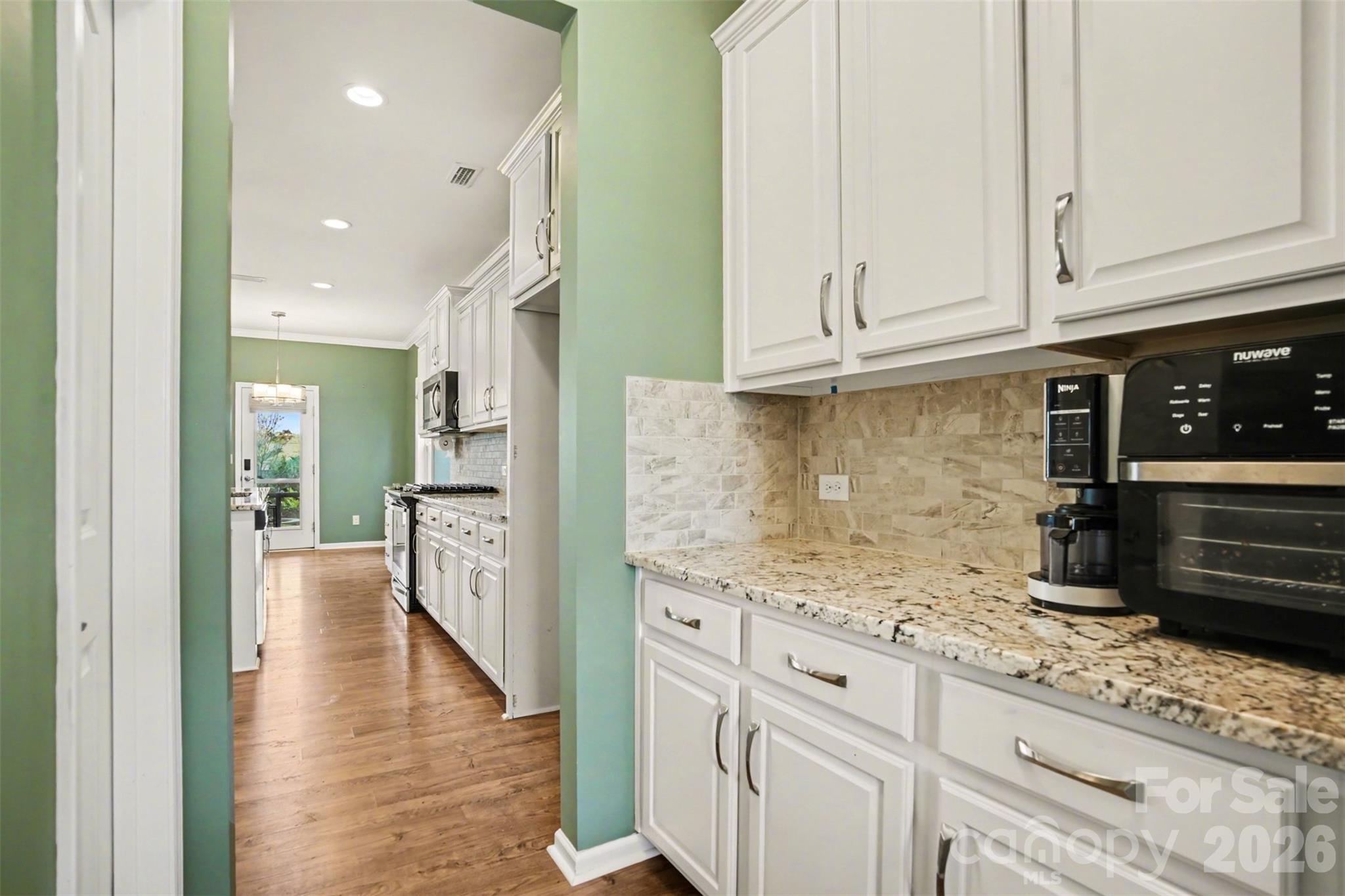 2013 Fuschia Court Tega Cay, SC 29708 - Photo 8 of 47 a kitchen with granite countertop a sink stainless steel appliances and cabinets