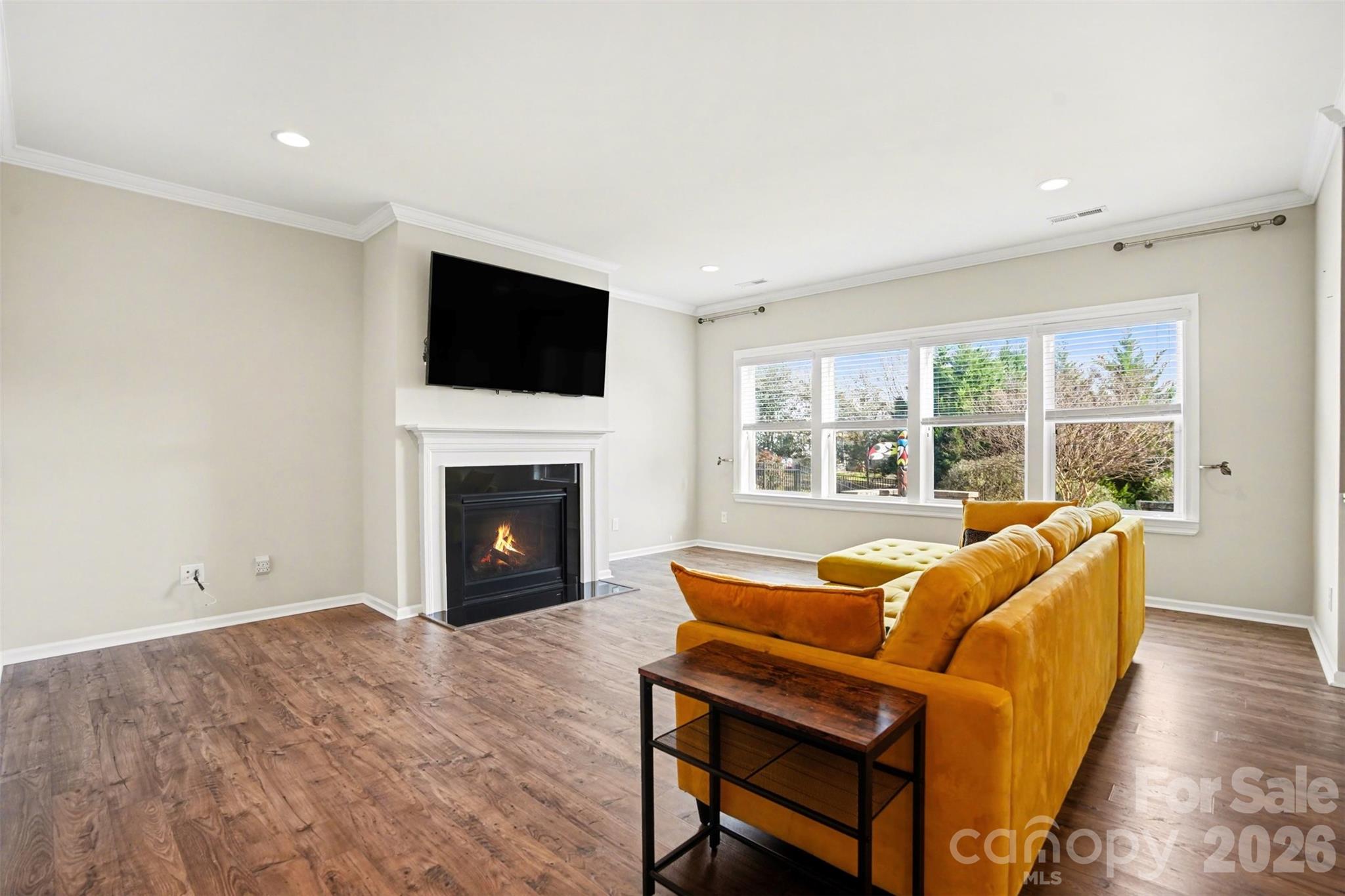 2013 Fuschia Court Tega Cay, SC 29708 - Photo 10 of 47 a living room with furniture a fireplace and a flat screen tv