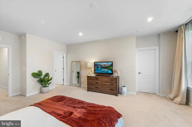 a bedroom with a bed and a dresser