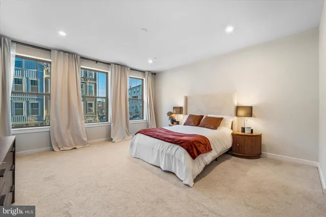 a spacious bedroom with a bed and glass door