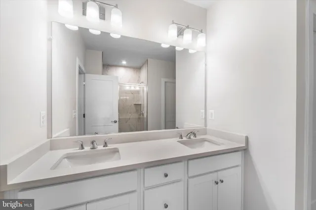a bathroom with a sink double vanity and a mirror