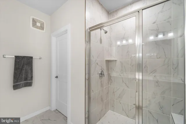 a bathroom with a glass shower door