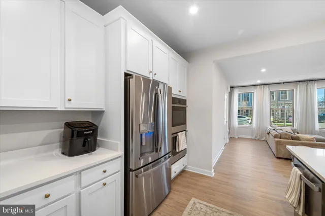 a kitchen with stainless steel appliances a refrigerator sink and cabinets