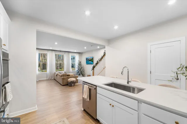 a kitchen with a sink and living room
