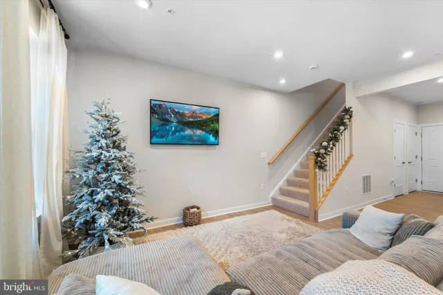a view of a bedroom with wooden floor and stairs