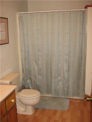 516 Brasfield Road Dresden, TN 38225 - Photo 3 of 14 a bathroom with a shower curtain and a toilet