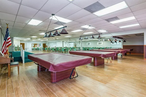 a room with furniture and pool table