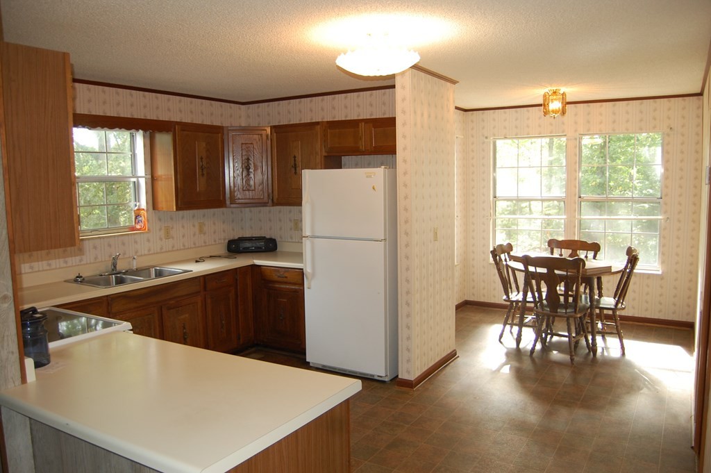 289 Dogwood Circle Decatur, TN 37322 - Photo 13 of 42 a kitchen with a table chairs refrigerator and window