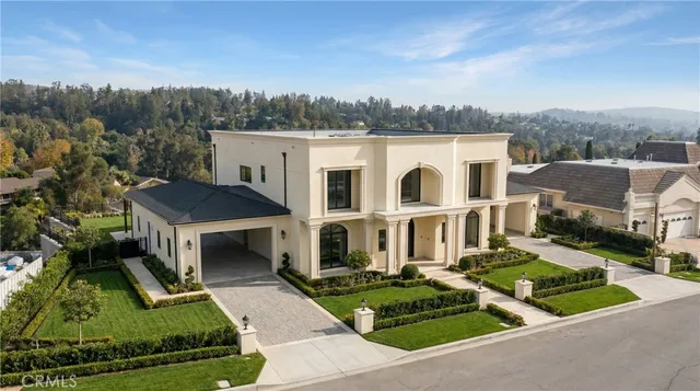 an aerial view of a house with a yard table and chairs